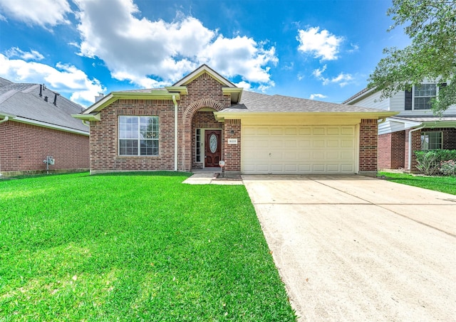 traditional-style home with an attached garage, driveway, brick siding, and a front yard