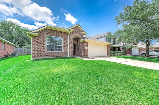 traditional-style home with central AC unit, a garage, brick siding, and driveway