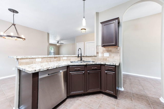 kitchen with a sink, stainless steel dishwasher, dark brown cabinets, decorative backsplash, and a peninsula