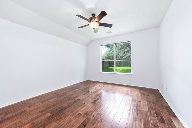 spare room with dark wood-style flooring, ceiling fan, lofted ceiling, and baseboards