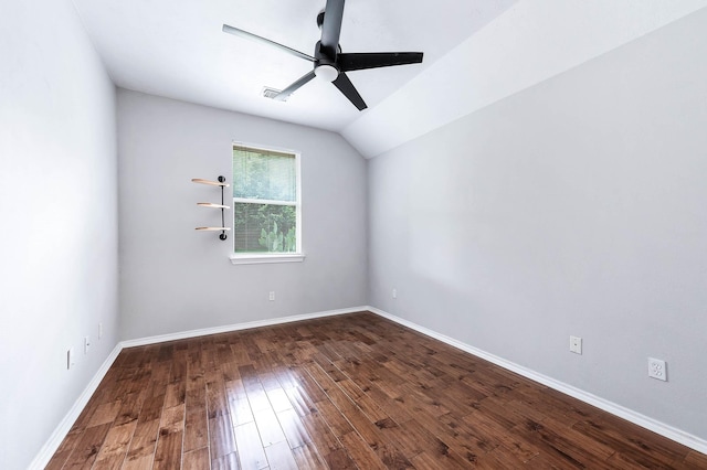 spare room featuring a ceiling fan, wood finished floors, vaulted ceiling, and baseboards
