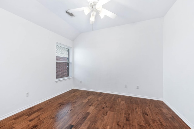 unfurnished room with dark wood-style flooring, vaulted ceiling, a ceiling fan, and baseboards