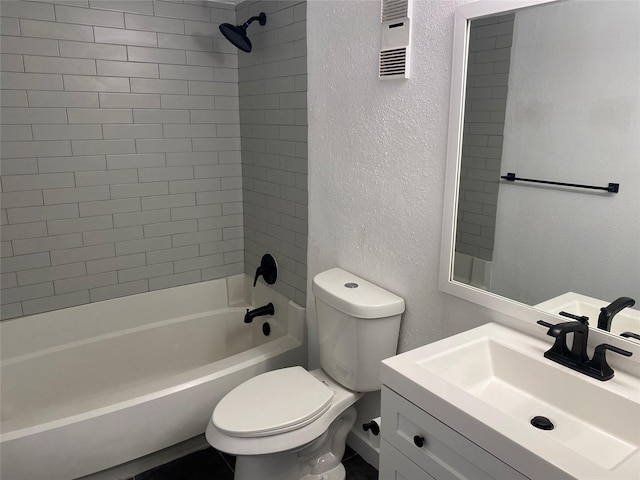bathroom with shower / bath combination, a textured wall, toilet, and vanity