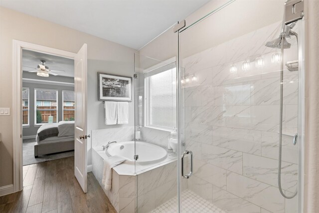ensuite bathroom with a ceiling fan, a shower stall, ensuite bathroom, wood finished floors, and a bath