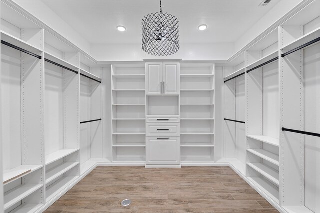 spacious closet featuring light wood-style flooring