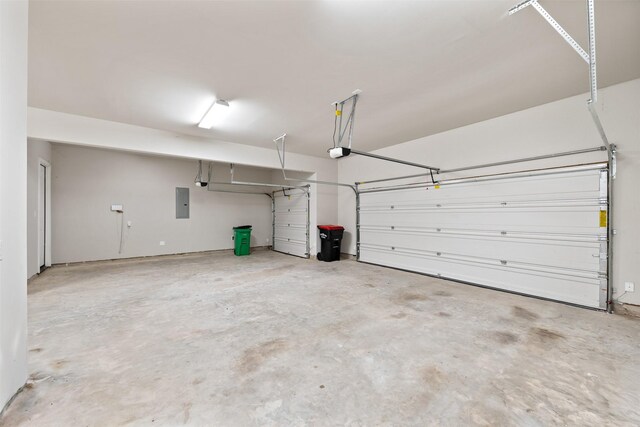 garage with a garage door opener and electric panel