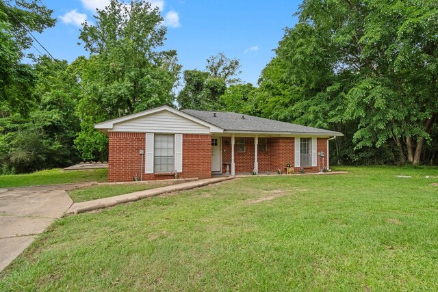 ranch-style house featuring brick siding and a front yard