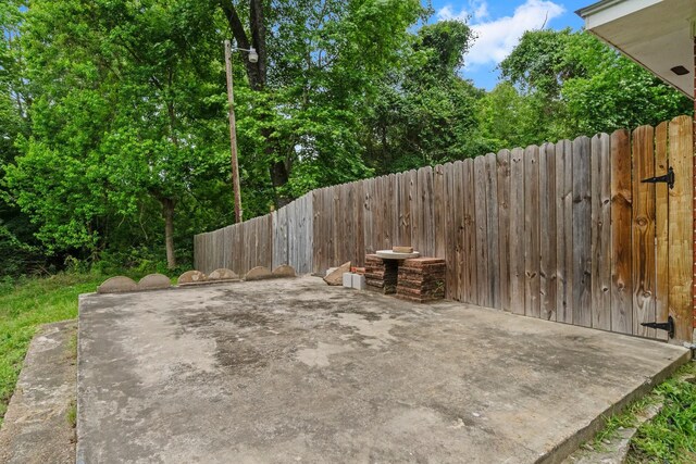 view of patio featuring fence