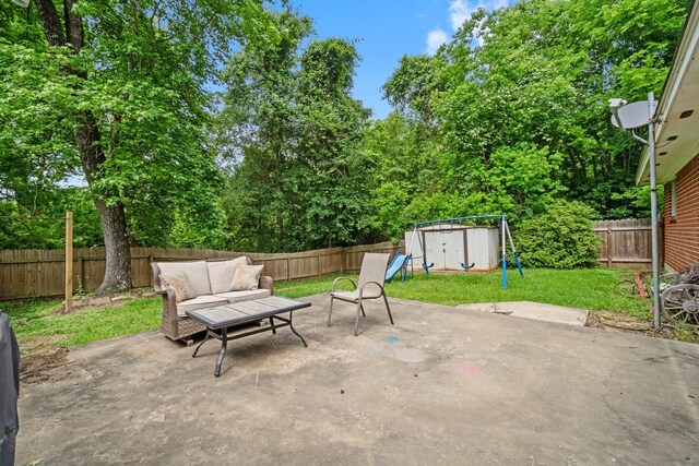view of patio featuring an outdoor structure, a fenced backyard, a shed, and an outdoor living space