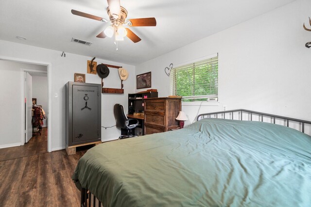 bedroom with visible vents, baseboards, ceiling fan, and wood finished floors
