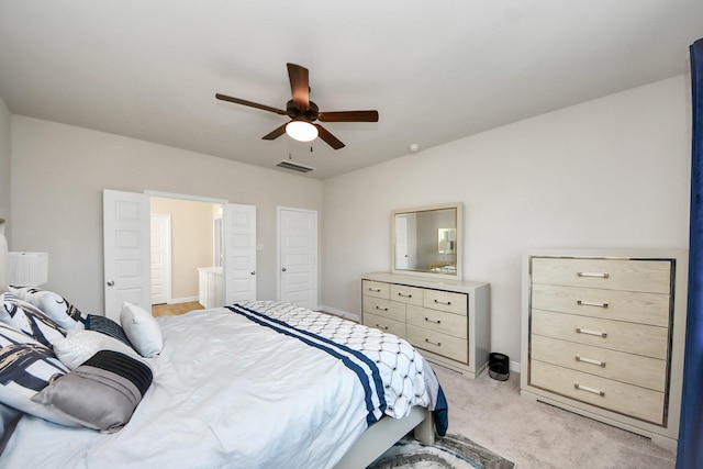 bedroom with light colored carpet, baseboards, visible vents, and ceiling fan