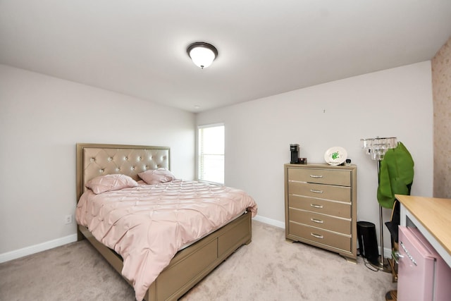 bedroom with baseboards and light colored carpet