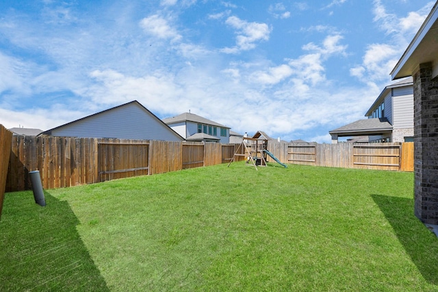 view of yard featuring a fenced backyard and a playground