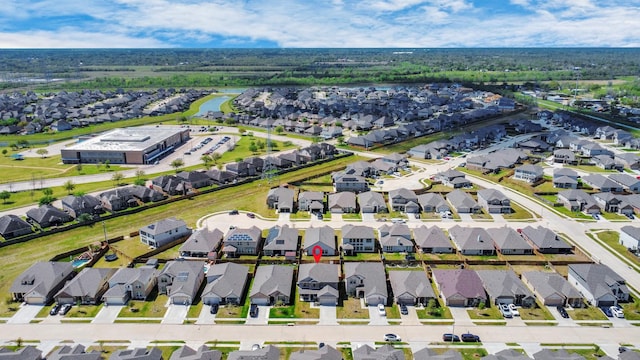 drone / aerial view with a water view and a residential view