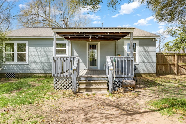 415 N Meyer St, Sealy, TX 77474 - rear view of house featuring fence, a wooden deck, and roof with shingles