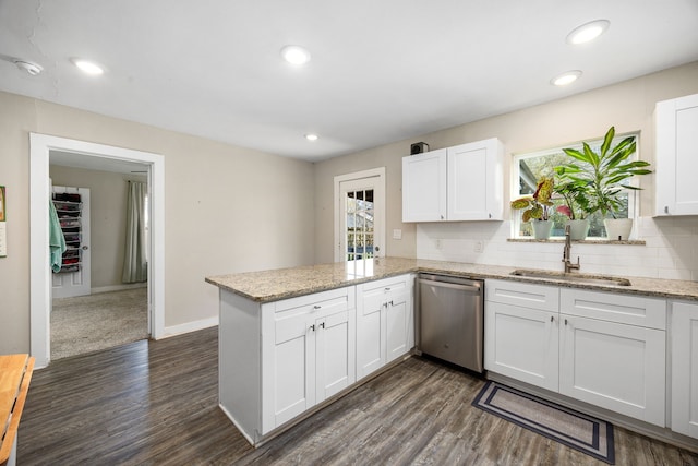 415 N Meyer St, Sealy, TX 77474 - kitchen featuring a peninsula, white cabinetry, a sink, dishwasher, and a wealth of natural light