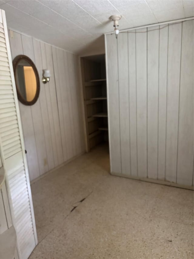 unfurnished bedroom with wood walls
