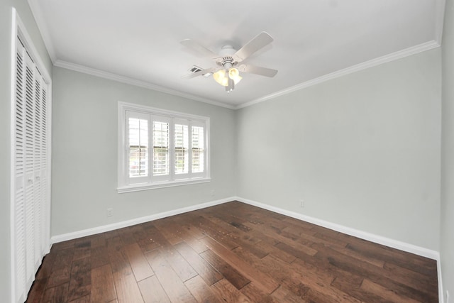 unfurnished bedroom featuring crown molding, baseboards, a closet, and dark wood finished floors