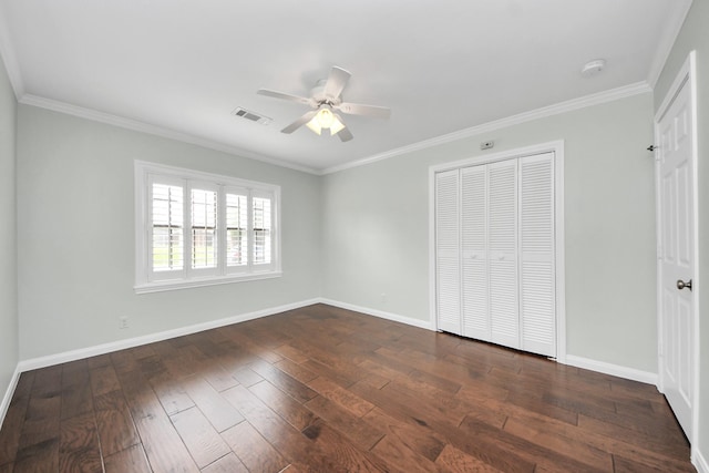 unfurnished bedroom with baseboards, visible vents, and dark wood-style floors