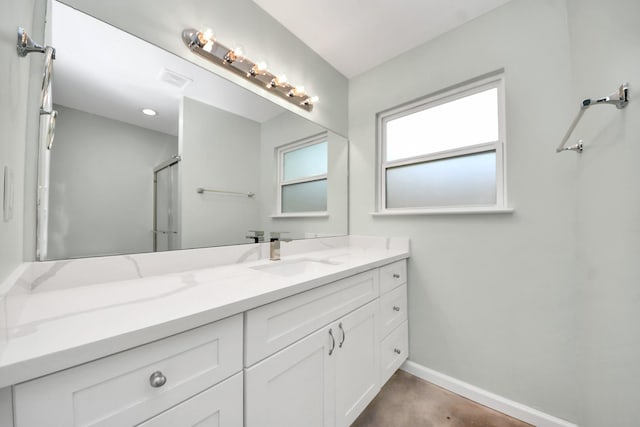 bathroom featuring concrete flooring, baseboards, and vanity