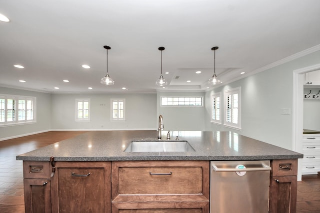 kitchen featuring crown molding, recessed lighting, a sink, and open floor plan