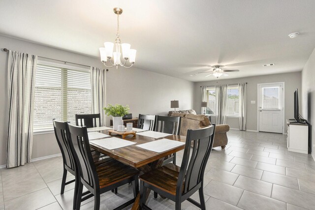 23706 Bluewood Trce, Tomball, TX 77375 - dining room featuring a chandelier, light tile patterned floors, baseboards, and ceiling fan