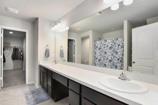 23706 Bluewood Trce, Tomball, TX 77375 - full bathroom featuring tile patterned flooring, double vanity, a spacious closet, baseboards, and a shower with curtain