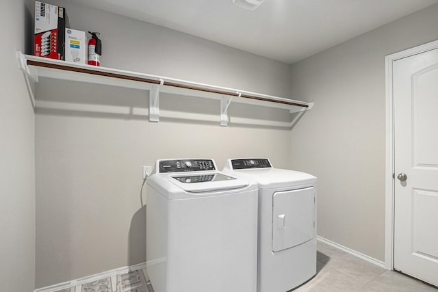23706 Bluewood Trce, Tomball, TX 77375 - clothes washing area with washer and dryer, baseboards, and light tile patterned flooring