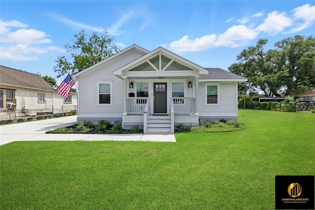 bungalow-style home with covered porch, cooling unit, and a front lawn