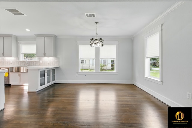 unfurnished dining area featuring visible vents, crown molding, and plenty of natural light
