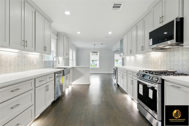 kitchen with a sink, light countertops, tasteful backsplash, and stainless steel appliances