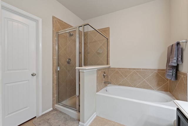 bathroom featuring a shower stall and a garden tub
