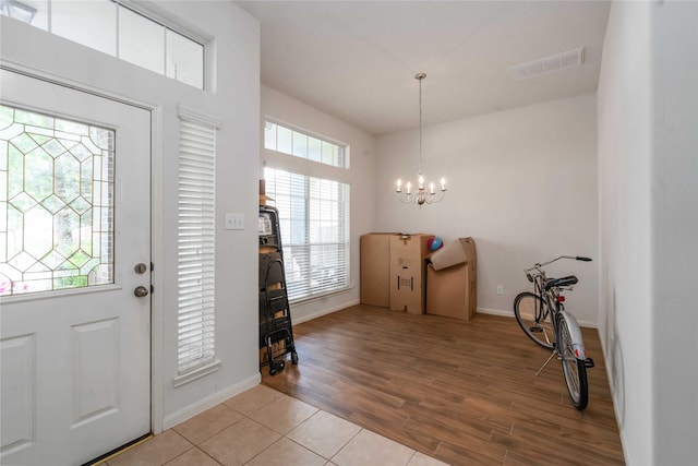 102 Pebble Walk Ln, Dickinson, TX 77539 - entryway featuring a chandelier, baseboards, and light wood finished floors