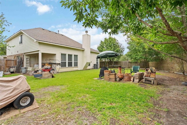 102 Pebble Walk Ln, Dickinson, TX 77539 - rear view of property with a chimney and a shingled roof