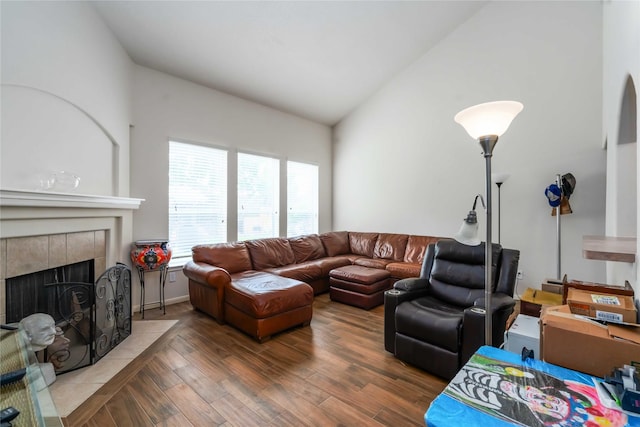 102 Pebble Walk Ln, Dickinson, TX 77539 - living room with lofted ceiling, a tiled fireplace, and wood finished floors