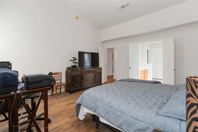 102 Pebble Walk Ln, Dickinson, TX 77539 - bedroom featuring wood finished floors, an office area, and high vaulted ceiling