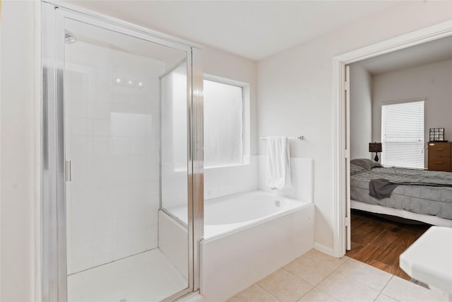 102 Pebble Walk Ln, Dickinson, TX 77539 - full bathroom featuring a shower stall, ensuite bathroom, tile patterned floors, and a garden tub