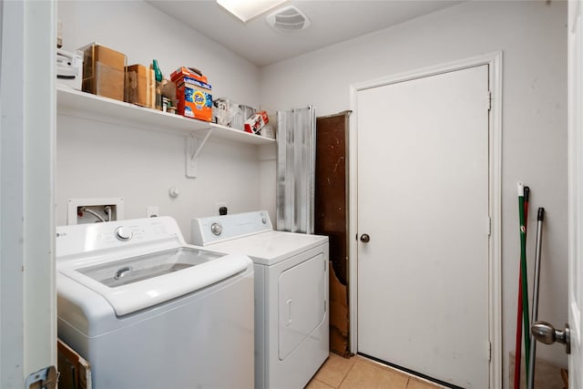 102 Pebble Walk Ln, Dickinson, TX 77539 - washroom featuring separate washer and dryer and light tile patterned floors