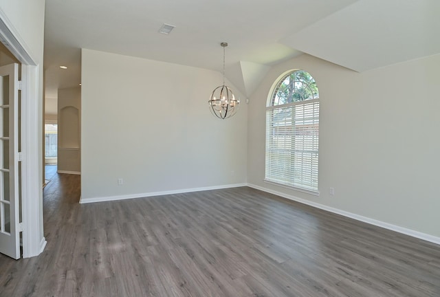 unfurnished dining area featuring baseboards, visible vents, a chandelier, and dark wood-type flooring