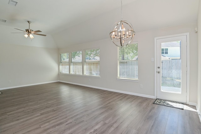 unfurnished dining area featuring visible vents, wood finished floors, baseboards, ceiling fan with notable chandelier, and lofted ceiling