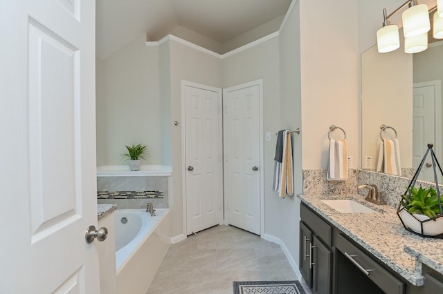 full bathroom with tile patterned flooring, vanity, baseboards, a bath, and a closet