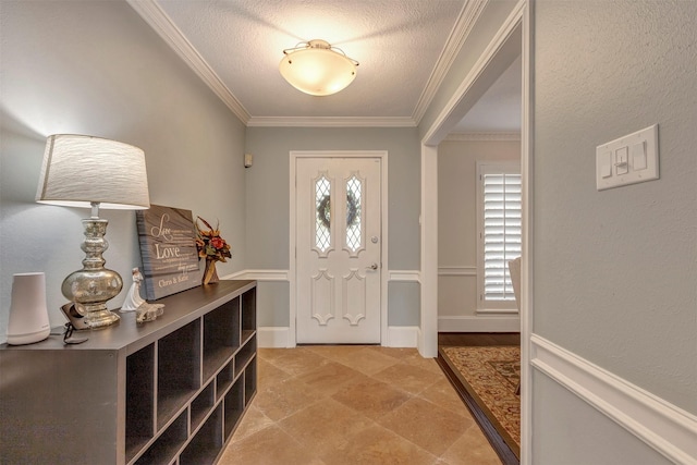 foyer entrance with crown molding and a textured ceiling