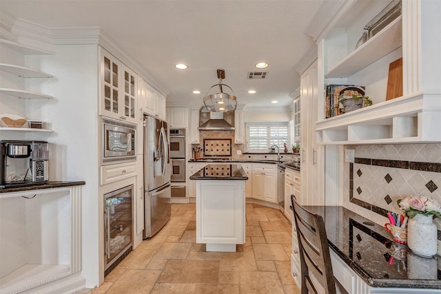 kitchen featuring open shelves, appliances with stainless steel finishes, wall chimney exhaust hood, stone tile floors, and visible vents