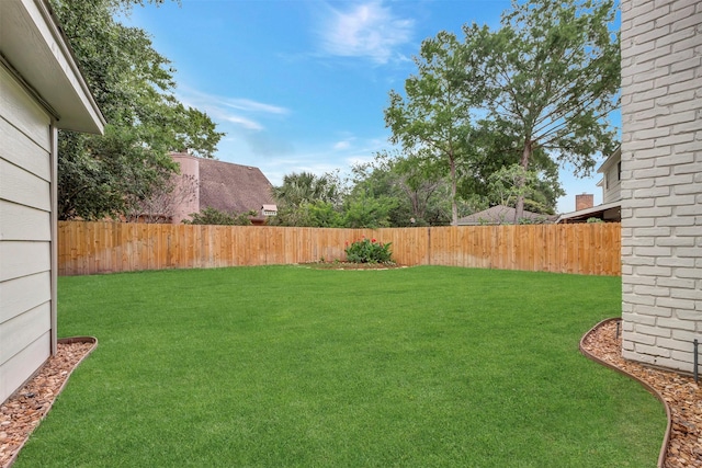 view of yard with a fenced backyard