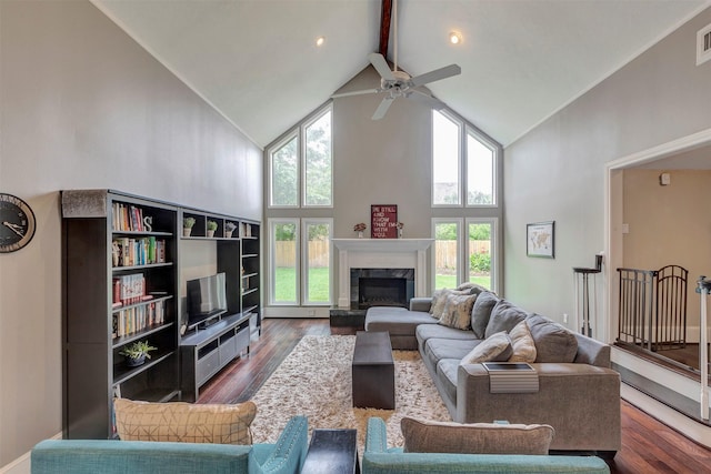 living room with a ceiling fan, visible vents, a high end fireplace, high vaulted ceiling, and dark wood-type flooring