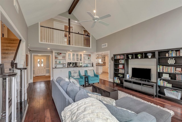 living area featuring visible vents, beam ceiling, high vaulted ceiling, a ceiling fan, and dark wood finished floors