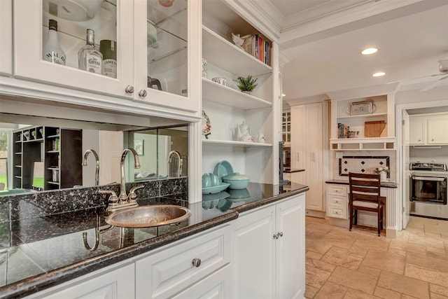 bar featuring stove, a sink, stone tile flooring, ornamental molding, and recessed lighting