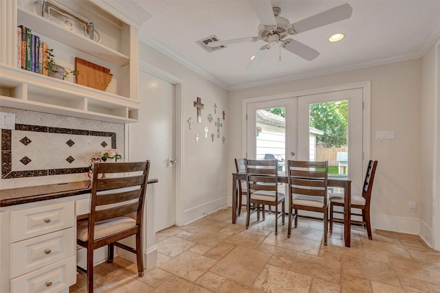dining area with visible vents, stone tile floors, ornamental molding, baseboards, and french doors