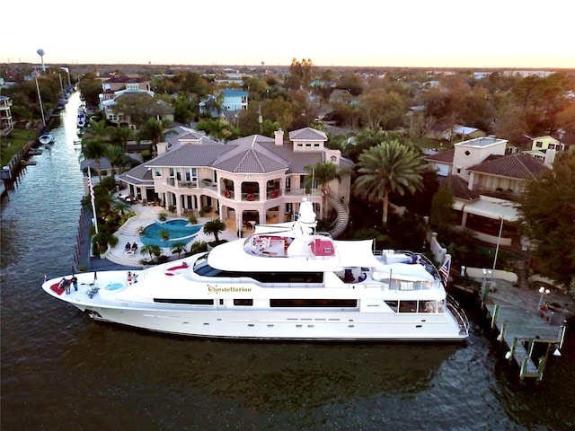 aerial view at dusk featuring a water view