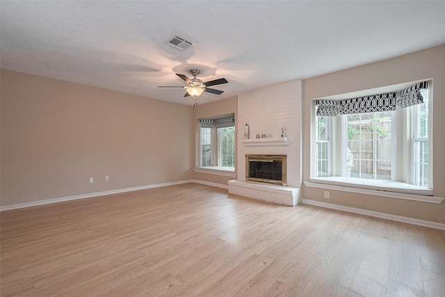 772 Thicket Ln, Houston, TX 77079 - unfurnished living room with baseboards, a fireplace, light wood-type flooring, and visible vents